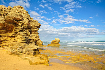 Sculptured rocks under blue sky and light clouds at Point Lonsdale, Victoria, Australia