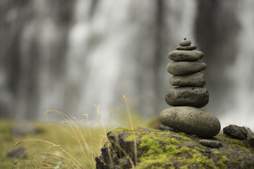 Stack of pebbles and waterfall