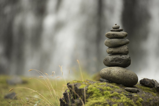 Stack of pebbles and waterfall