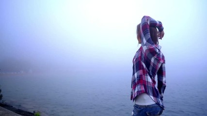 Lifestyle woman having fun walking sea. Stylish joyful woman with long hair having fun. Emotions of joy and happiness. Lifestyle concept. Walking woman on sea pier