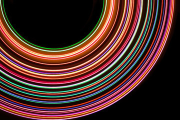 Neon color glowing lights texture with black empty copy space inside.