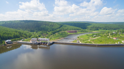 Fototapeta premium Panorama of spillway on old hydroelectric power station in sunny day aerial view