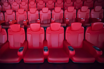 Red seat in the movie theater. Blurry background.