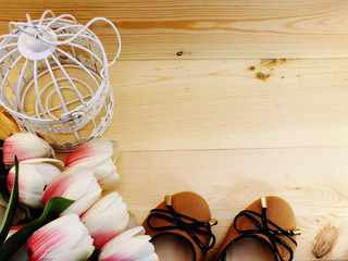 woman flats shoes and tulips flower on wooden background