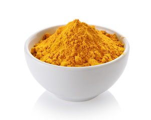 Turmeric powder in white cup on white background