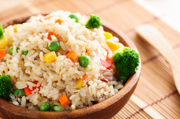 colorful fired rice on wooden bowl