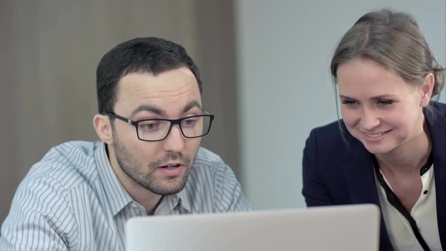 Two teacher working on laptop in class