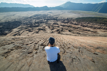 Man on top of Layer Volcanic ash as sand ground of Mount Bromo volcano (Gunung Bromo) at Bromo Tengger Semeru National Park, East Java, Indonesia