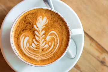latte art coffee or cappuccino on wooden table background