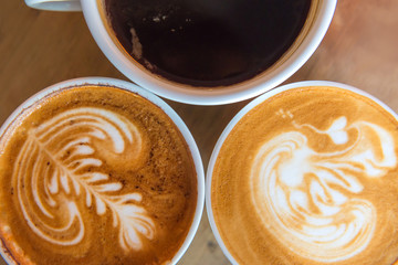 latte art coffee or cappuccino on wooden table background