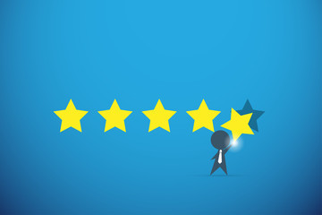 businessman holding gold star for rating, quality and business concept