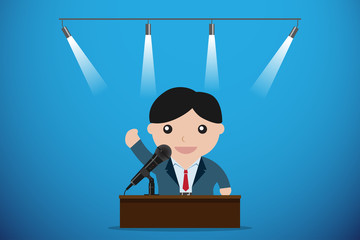 businessman speaking with microphone behind a table, speech and business concept