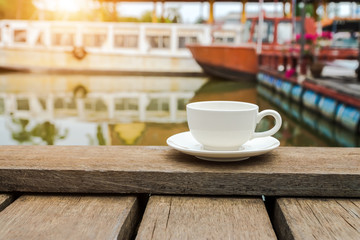 White coffee cup on wood floor.