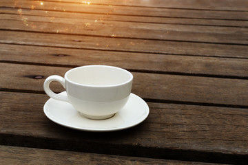 White coffee cup on wood floor.
