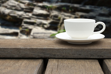 White coffee cup on wood floor.