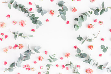 Flowers composition. Round floral frame made of rose flowers and eucalyptus branches on white background. Flat lay, top view, copy space