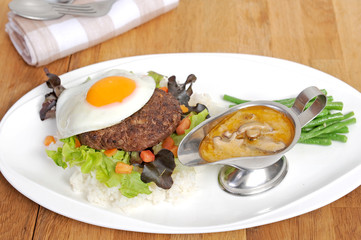 beef with black pepper and fried egg on rice