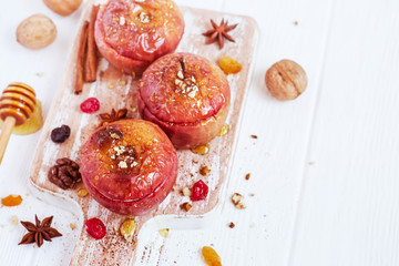 Red baked apples with cinnamon, walnuts and honey. Healthy Diet Dessert.