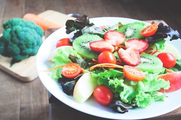 Closrup of fresh salad with strawberries on top