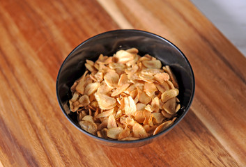 Garlic fry on the wooden background