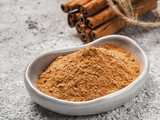 Ground cinnamon on gray background