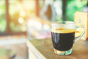 Black coffee in a giant glass on the table for refresh you in the morning when late to bed at last night.