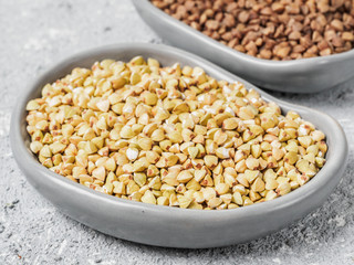Raw green buckwheat on gray background