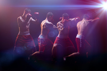 The boxer boxing in a dark studio