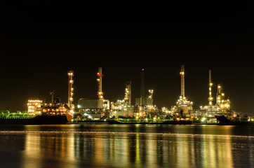 oil refinery with water reflections, petrochemical plant 