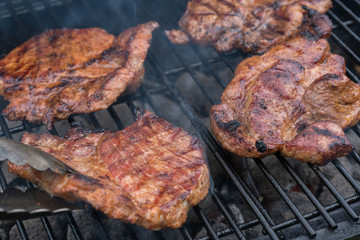 Delicious Grilled pork steak on the grill