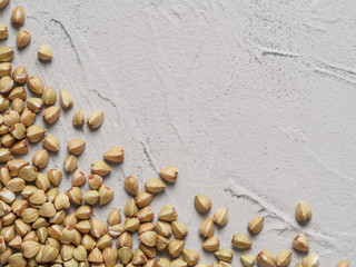 Fototapeta na wymiar Raw green buckwheat on gray concrete background