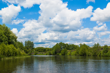 Fototapeta na wymiar Beautiful nature of Russia. The Tereshka River in summer. River, trees by the river and a beautiful cloudy sky