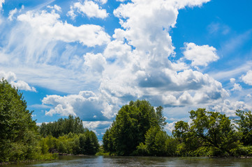 Beautiful nature of Russia. The Tereshka River in summer. River, trees by the river and a beautiful cloudy sky