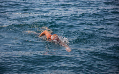 Swimming man in sea.