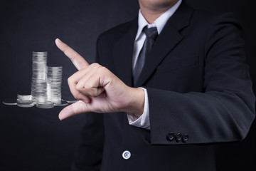 business man showing coin stack