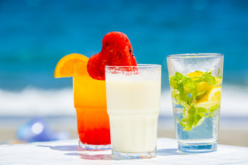 summer cocktails with a blur beach in the background