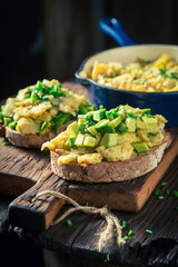Closeup of homemade fried eggs with chive and avocado