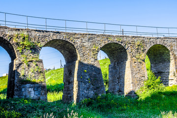 Fototapeta premium Arch bridge leading to medieval fortress of XIII century in Koporye, Leningradskaya Oblast, Russia