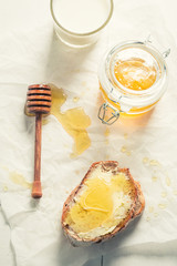 Top view of sandwich with honey and milk