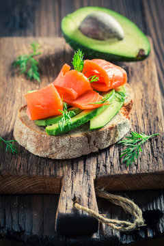 Closeup of fresh sandwich with salmon, avocadoa and dill