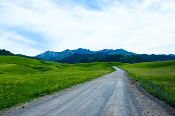 Off-road travel on mountain road. Beautiful mountains view, clouds and green valley.