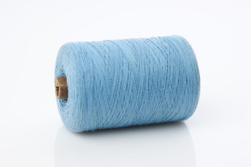 bobbin with blue thread on a white background