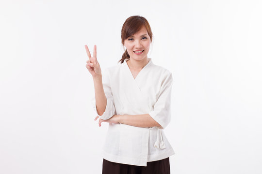 woman spa therapist pointing up 2 fingers, counting, numbering, victory hand sign
