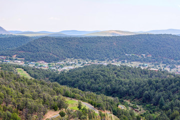 Fototapeta premium Beautiful sunset view to a little house residence in a town. United states of America, Ruidoso, New Mexico