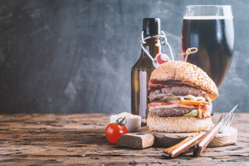 Hamburger and dark beer in vintage style