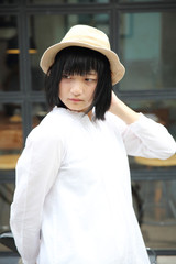 Asian young woman thinking and looking portrait with in coffee shop