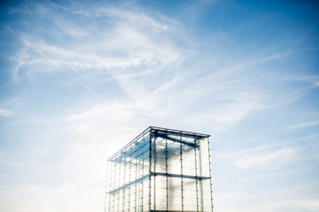 Modern transparent architectural structure on the blue sky background with copy space