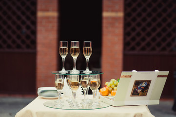 Many glasses on a table with alcohol and without