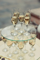 Many glasses on a table with alcohol and without