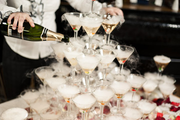 Many glasses on a table with alcohol and without